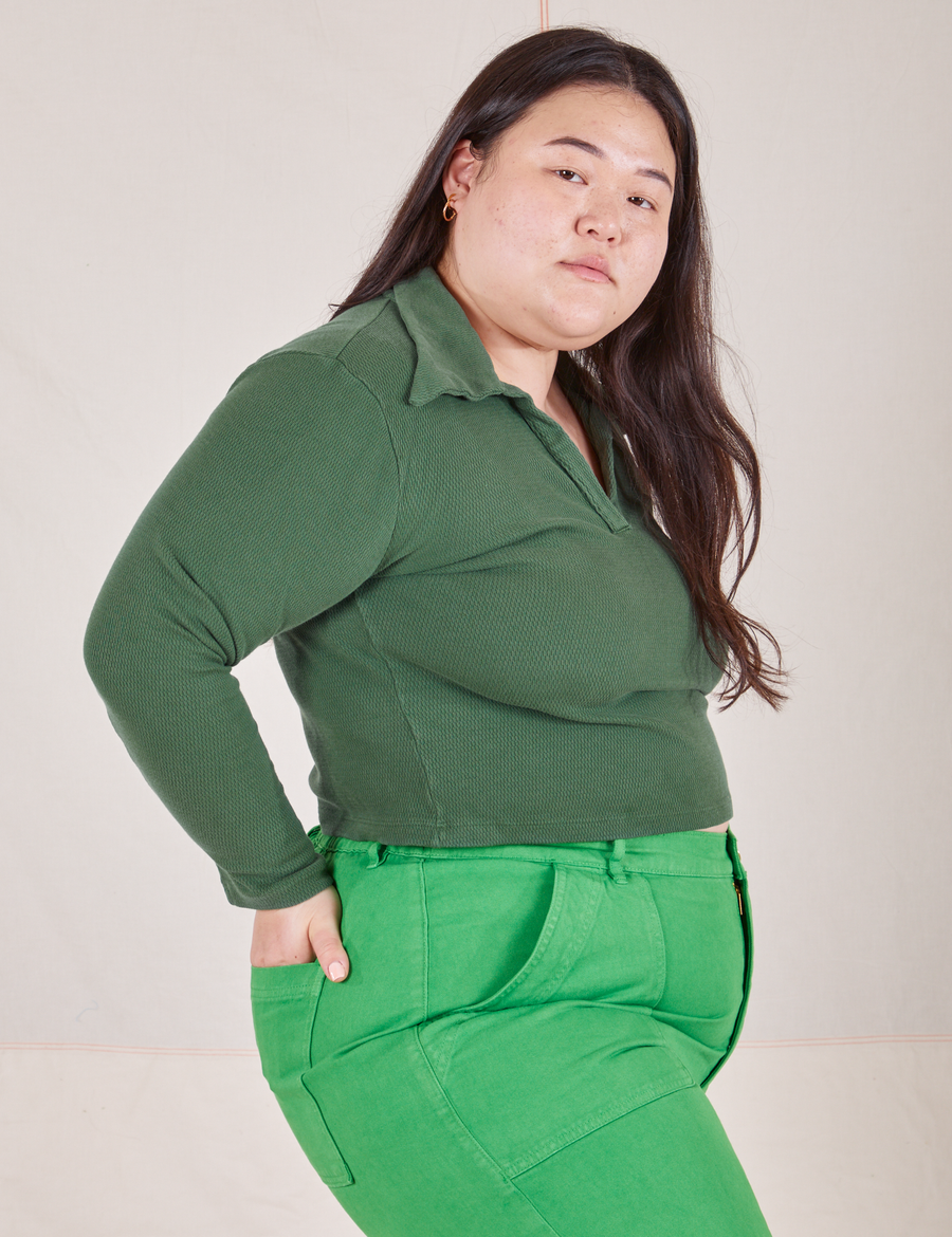 Long Sleeve Fisherman Polo in Dark Emerald Green side view on Ashley wearing kelly green Work Pants