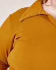 Front close up of Long Sleeve Fisherman Polo in Spicy Mustard worn by Catie