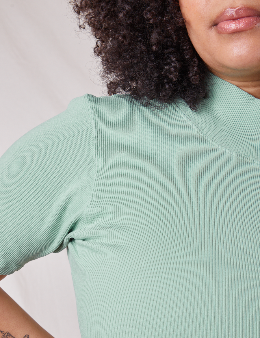 Front shoulder close up of 1/2 Sleeve Essential Turtleneck in Sage Green on Lana