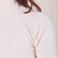 Front shoulder close up of 1/2 Sleeve Essential Turtleneck in Vintage Off-White on Alex