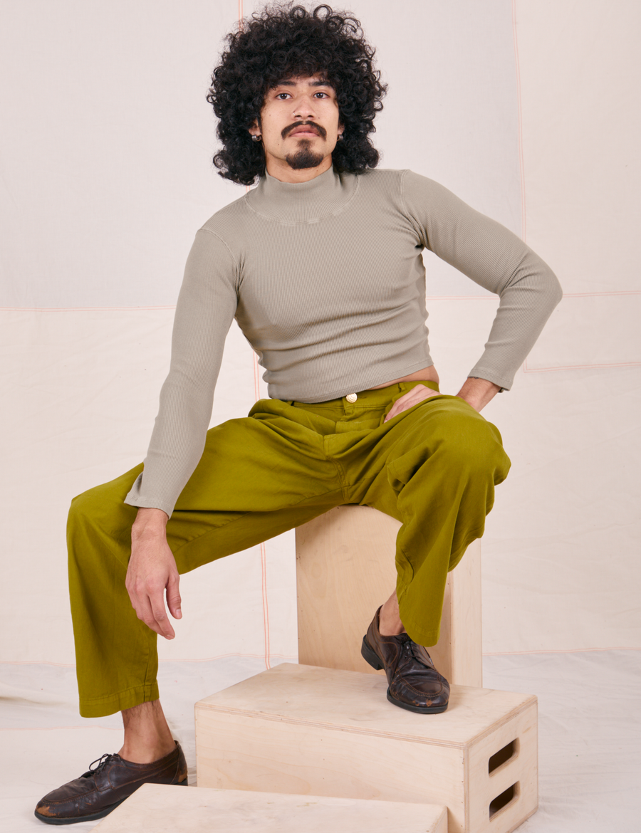 Jesse is wearing Essential Turtleneck in Khaki Grey