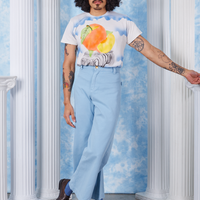 Peach Airbrush Organic Tee on Jesse tucked into baby blue Bell Bottoms