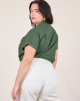 Angled back view of Pantry Button-Up in Dark Emerald Green worn by Faye