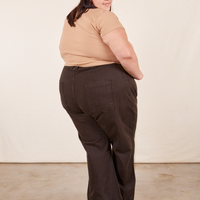 Back view of Western Pants in Espresso Brown paired with tan V-Neck Tee worn by Sarita