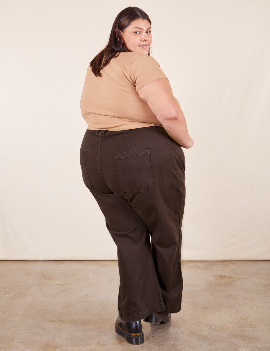 Back view of Western Pants in Espresso Brown paired with tan V-Neck Tee worn by Sarita