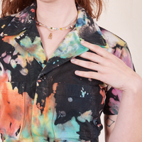 Short Sleeve Jumpsuit in Rainbow Magic Waters font close up on Alex