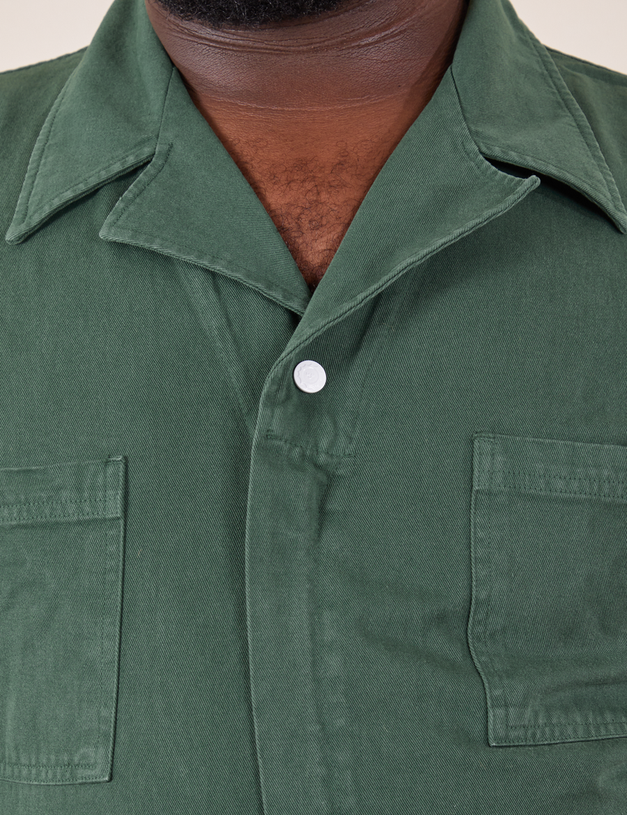 Front close up of Short Sleeve Jumpsuit in Dark Emerald Green worn by Elijah