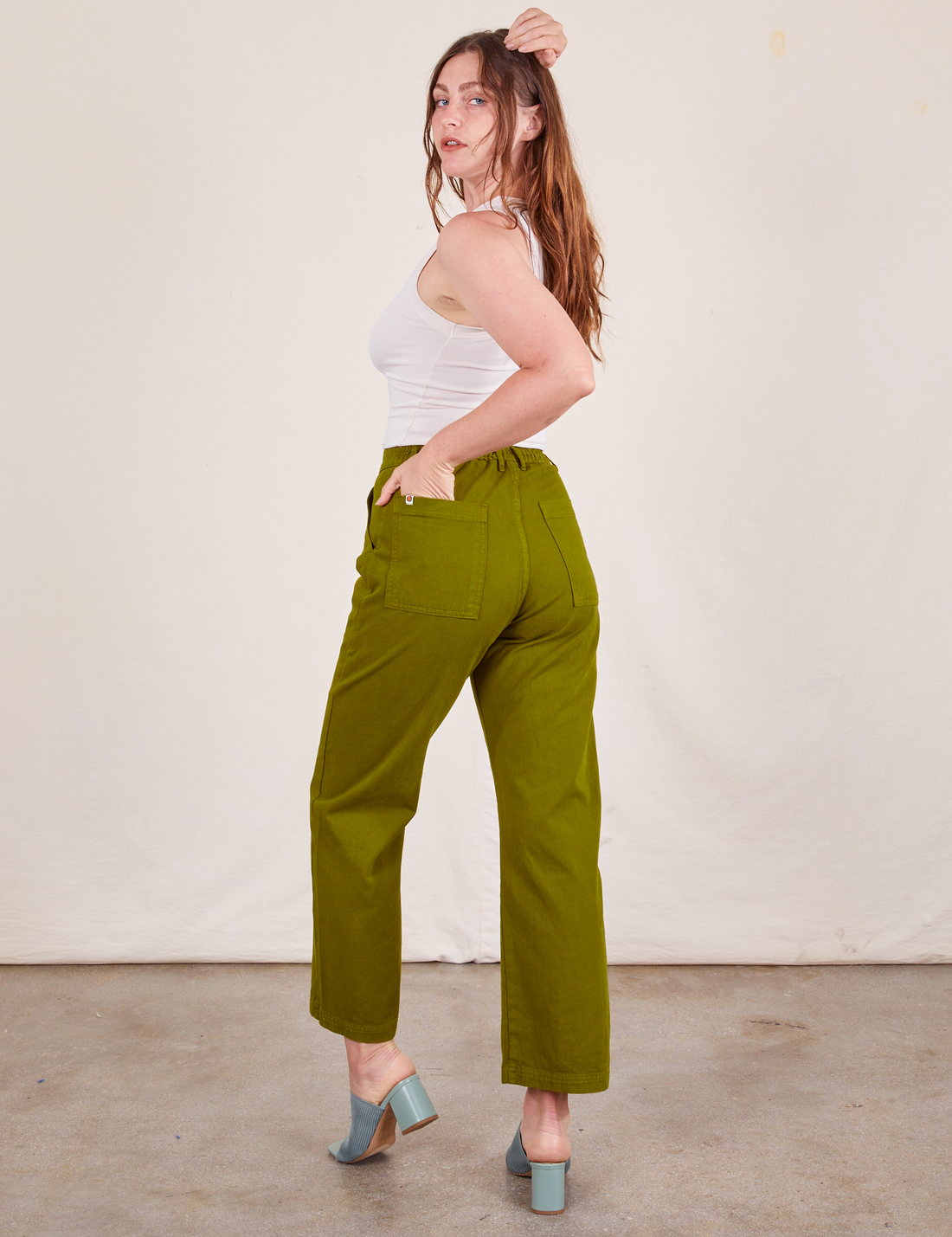Work Pants in Olive Green back view on Allison wearing vintage off-white Tank Top
