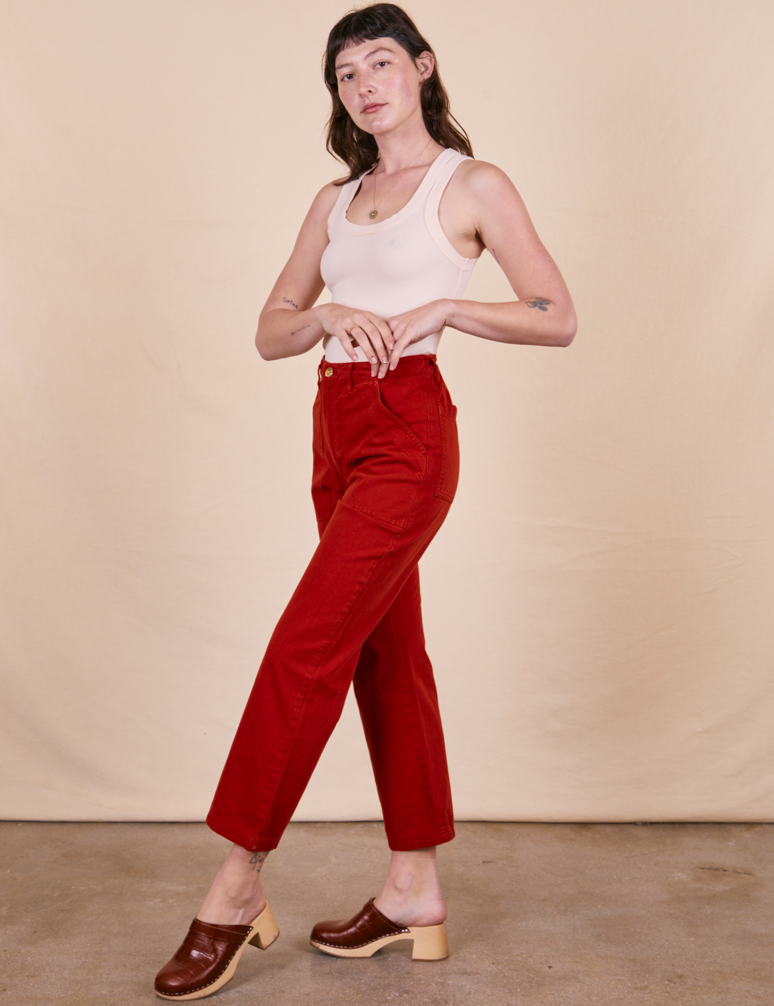Side view of Work Pants in Paprika on vintage off-white Tank Top on Alex