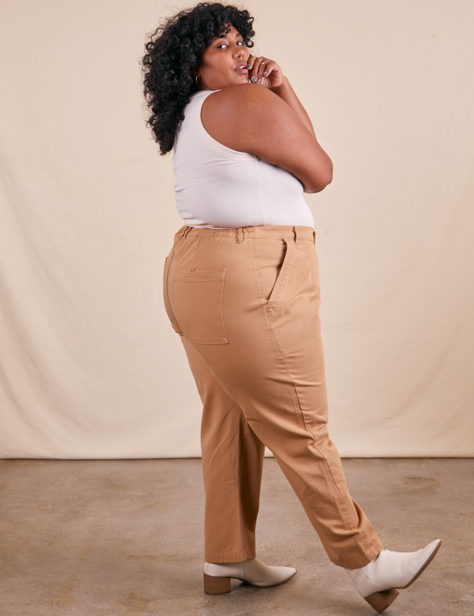 Side view of Work Pants in Tan and Tank Top in vintage tee off-white on Morgan