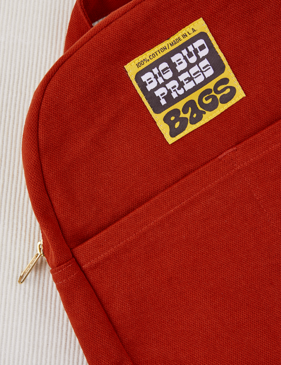 Mini Backpack in Paprika close up with brown and yellow Big Bud Press label