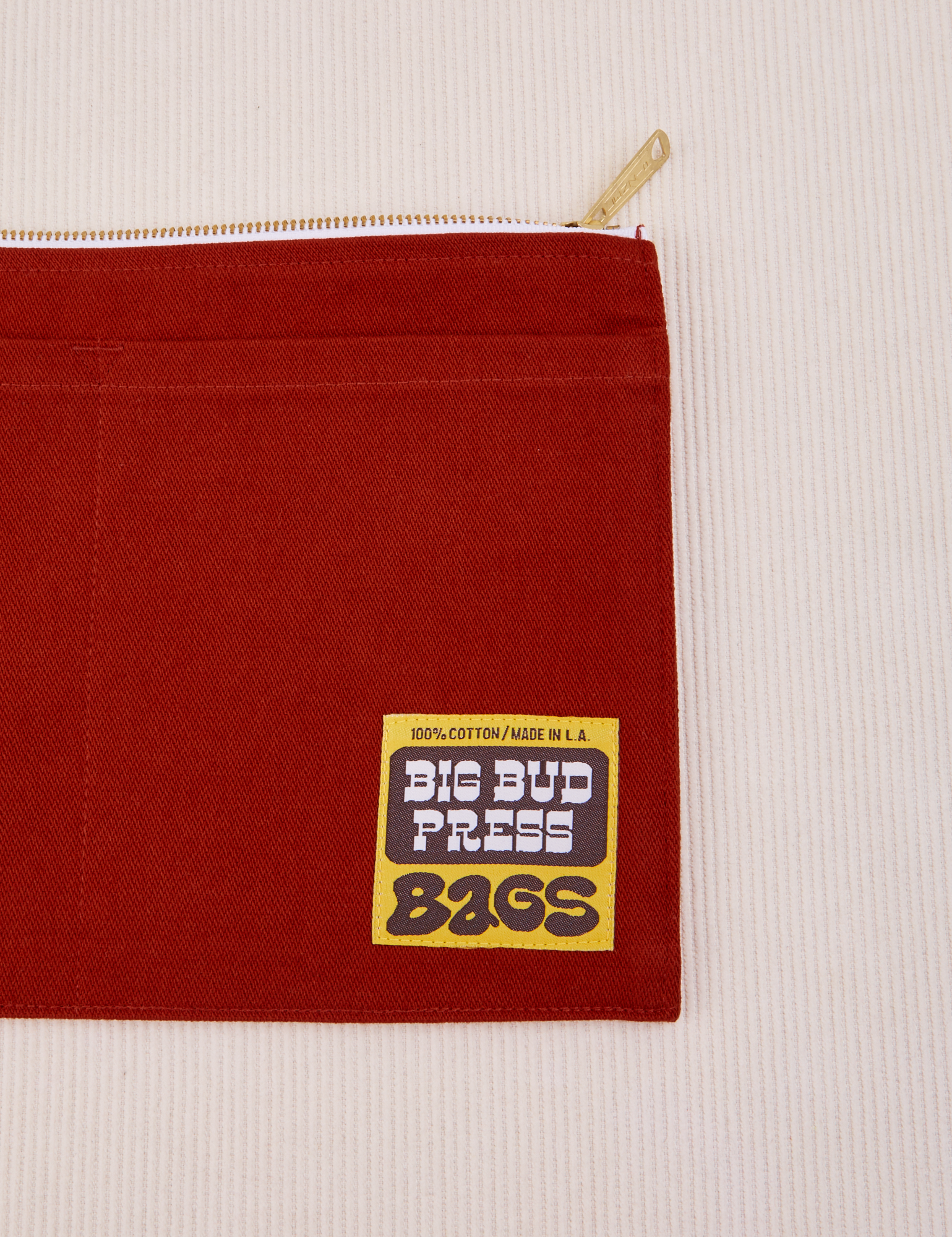 Big Pouch in Paprika with Big Bud Press label in brown and yellow