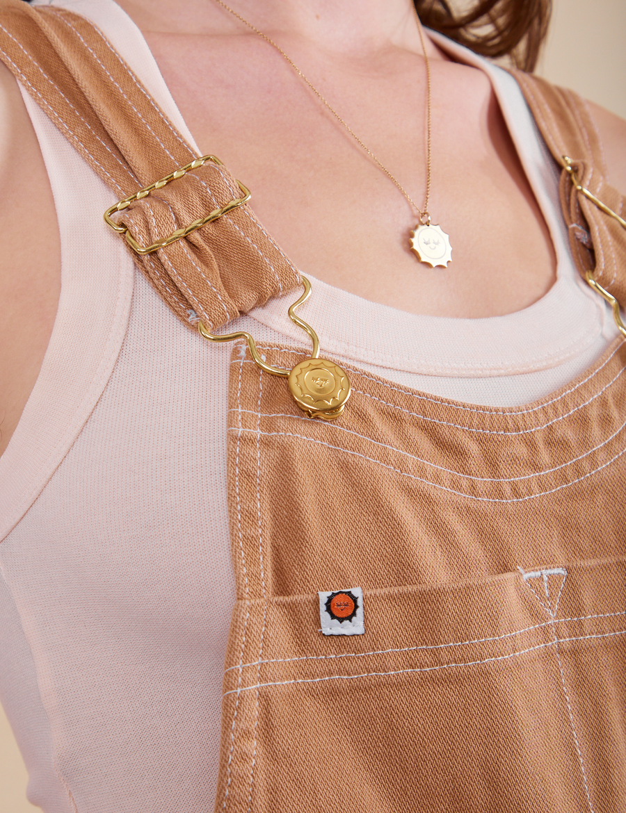 Original Overalls in Tan front close up with gold sun baby button and label