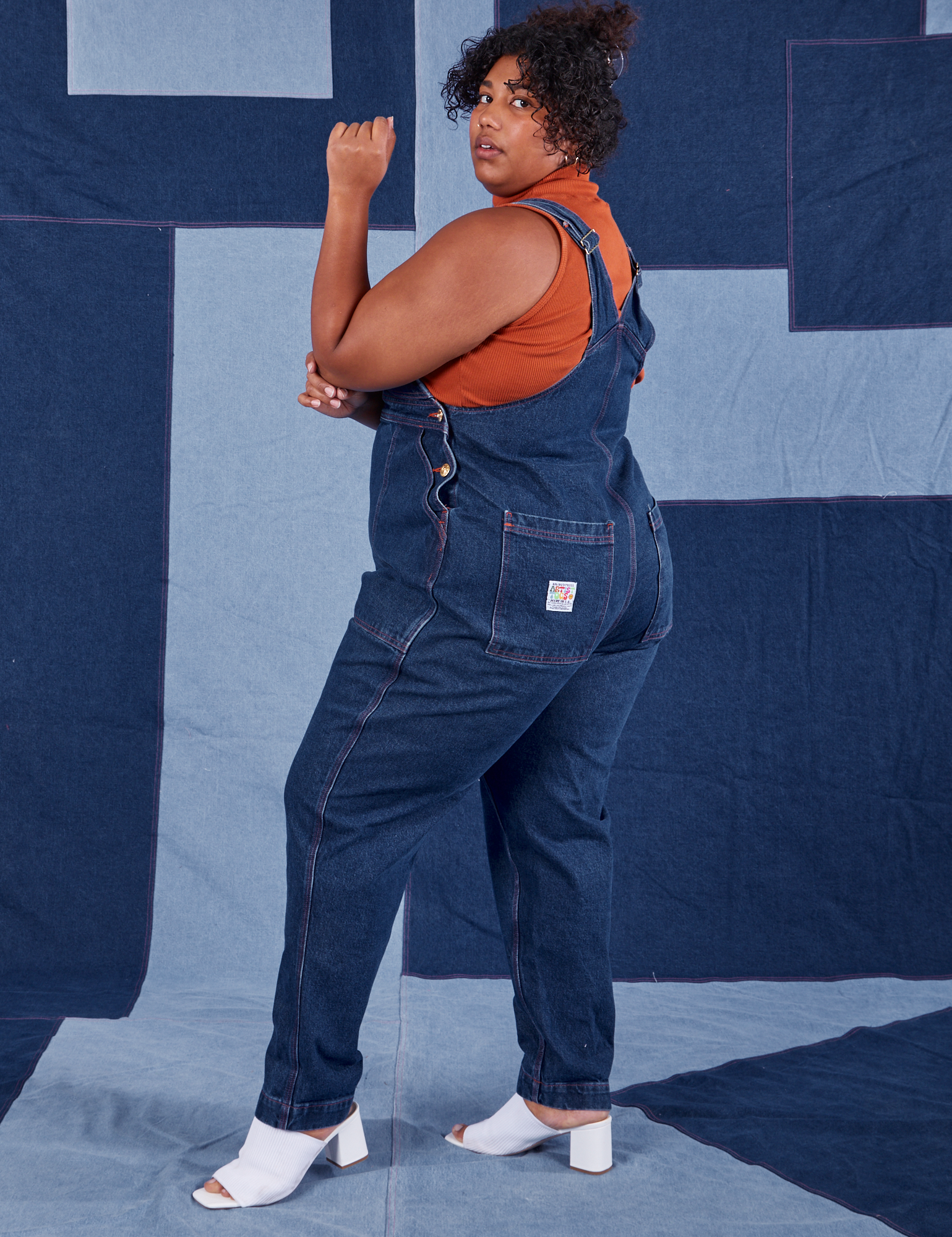 Side view of Indigo Denim Original Overalls in Dark Wash worn by Morgan