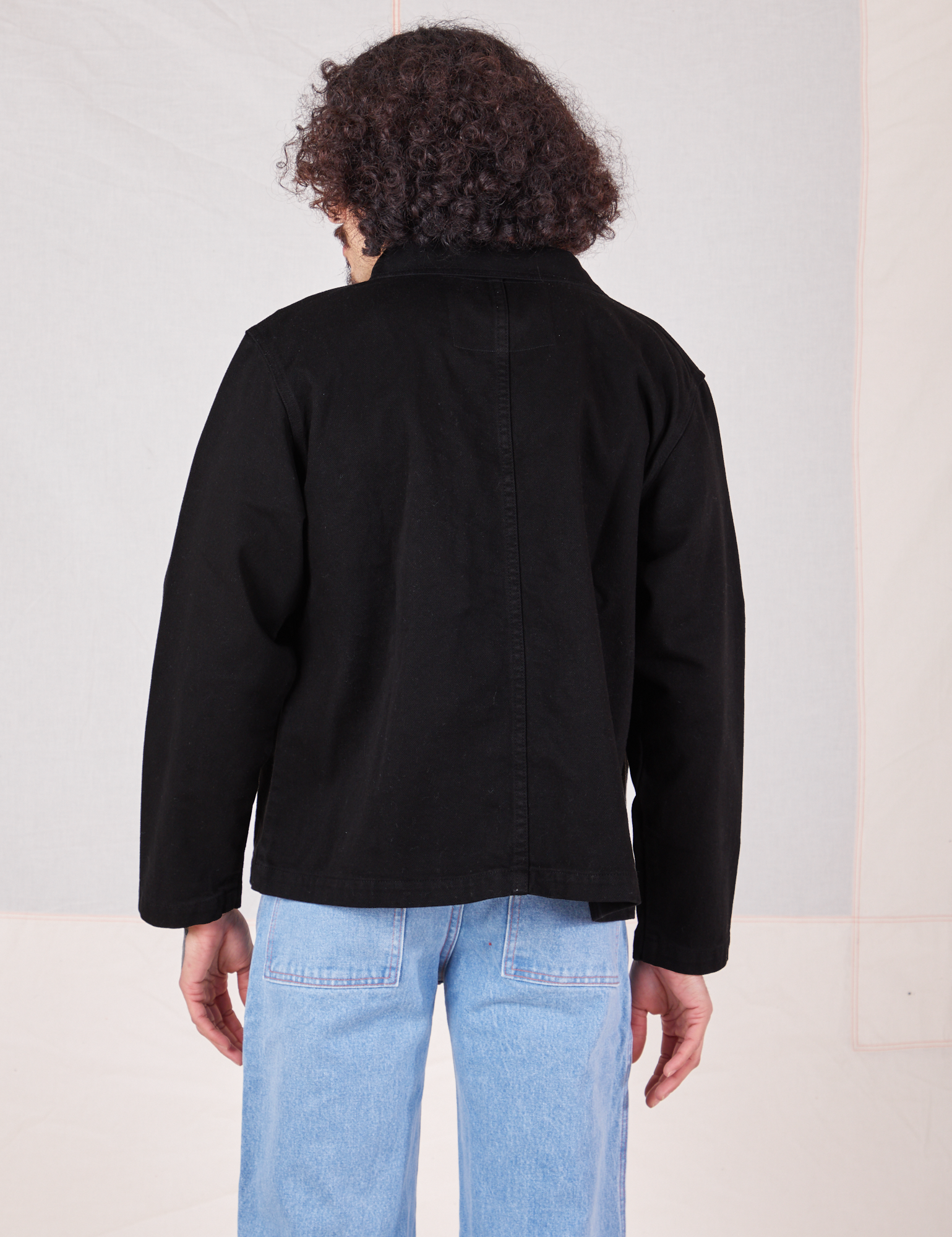 Back view of Denim Work Jacket in Basic Black worn by Jesse