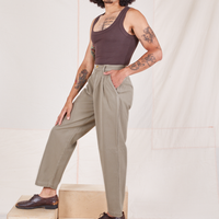 Side view of Heritage Trousers in Khaki Grey and espresso brown Tank Top worn by Jesse