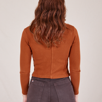 Back view of Long Sleeve Fisherman Polo in Burnt Terracotta worn by Alex