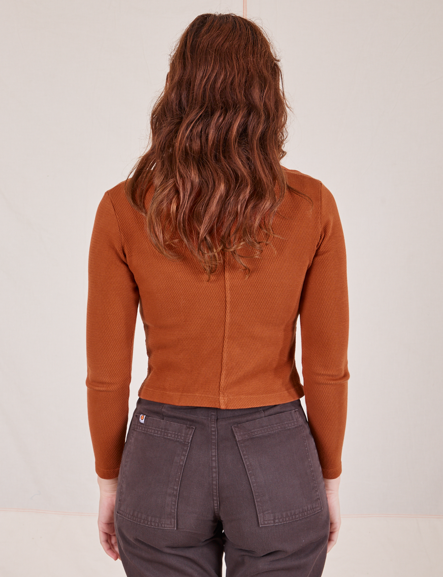 Back view of Long Sleeve Fisherman Polo in Burnt Terracotta worn by Alex