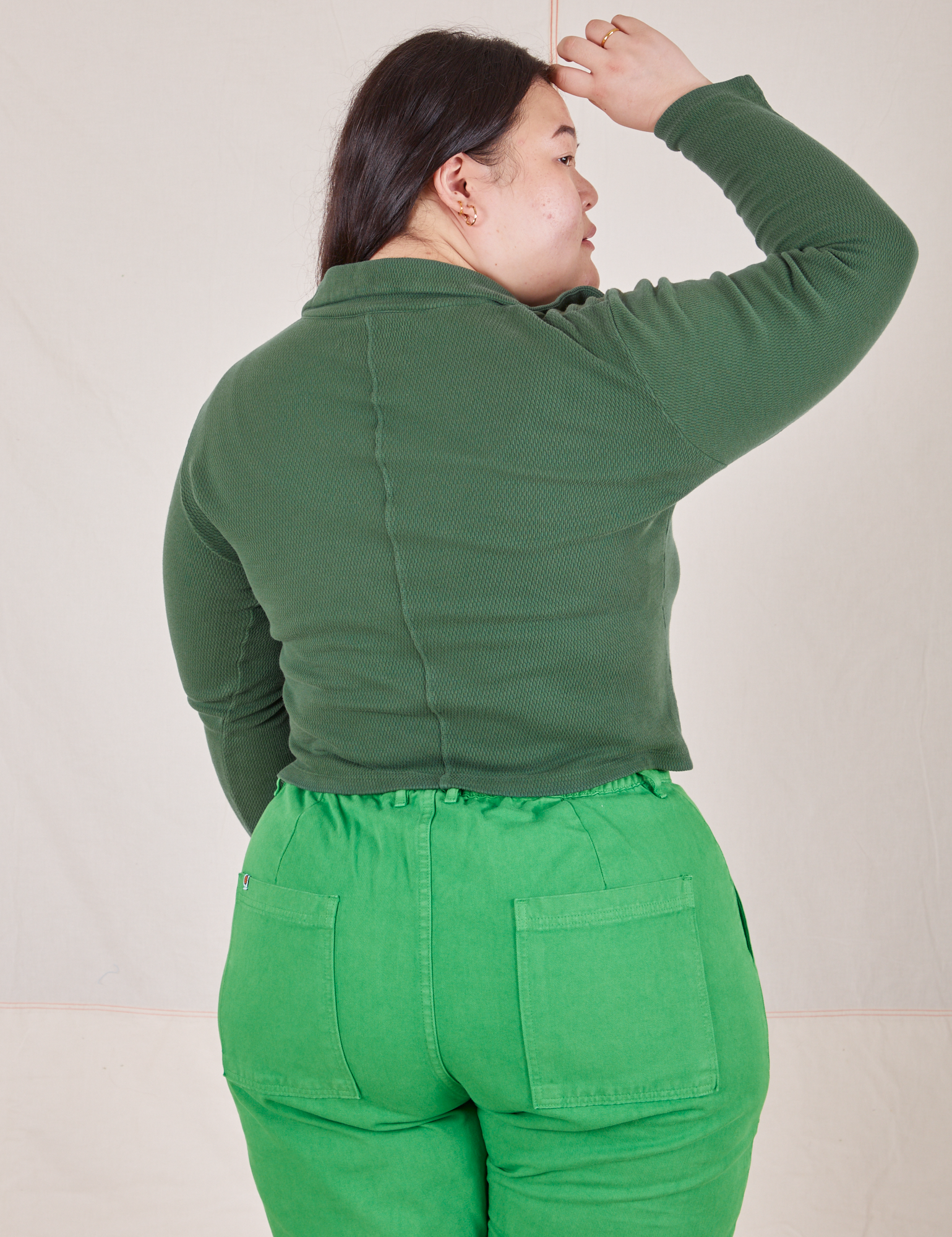 Back view of Long Sleeve Fisherman Polo in Dark Emerald Green worn by Ashley