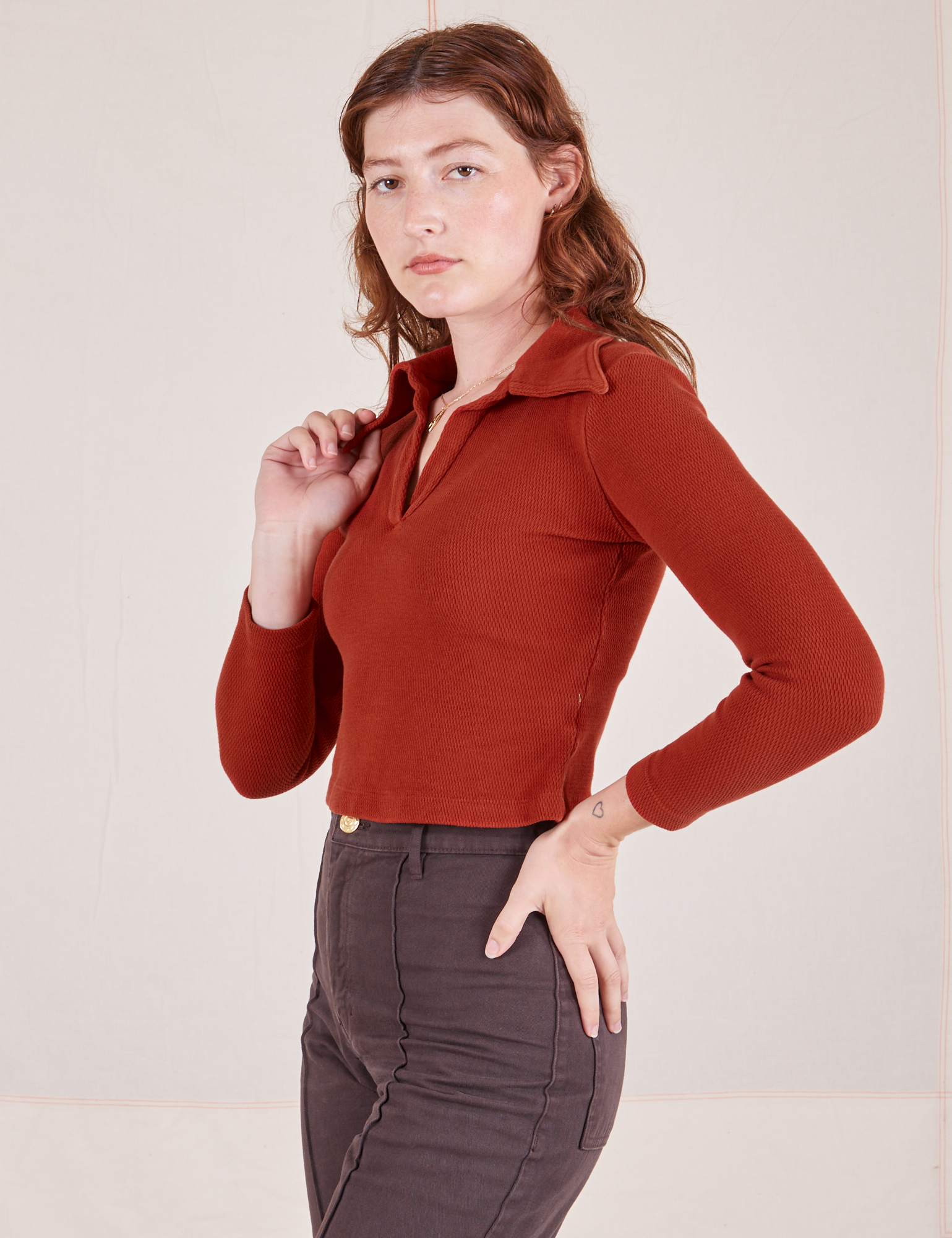 Angled view of Long Sleeve Fisherman Polo in Paprika worn by Alex