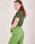 Side view of Organic Vintage Tee in Dark Emerald Green and gross green Western Pants worn by Alex