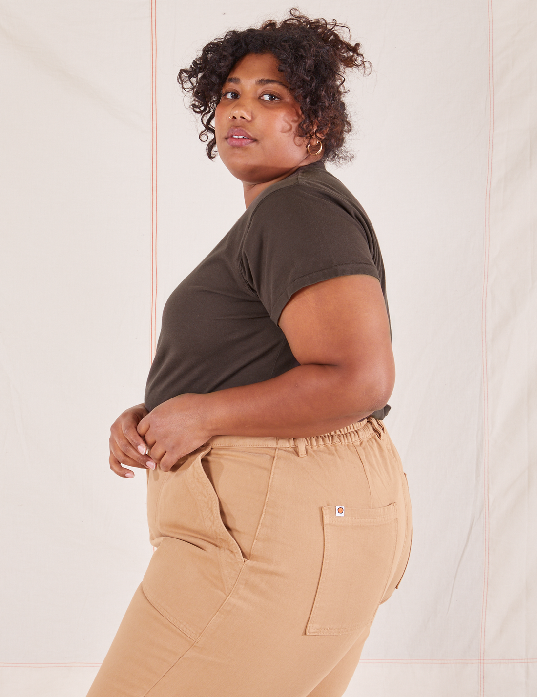 Side view of Organic Vintage Tee in Espresso Brown and tan Work Pants worn by Morgan