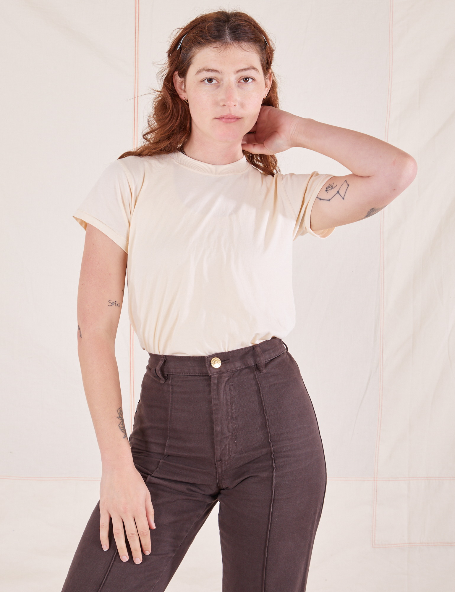 Alex is wearing Organic Vintage Tee in Sunshine Yellow tucked into espresso brown Western Pants