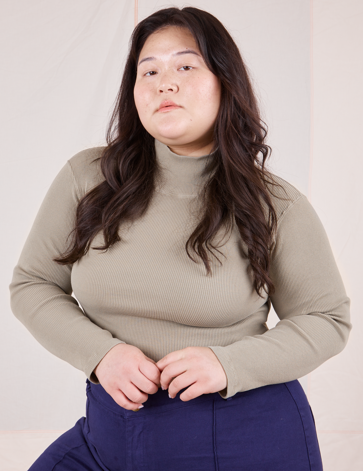 Ashley is wearing L Essential Turtleneck in Khaki Grey