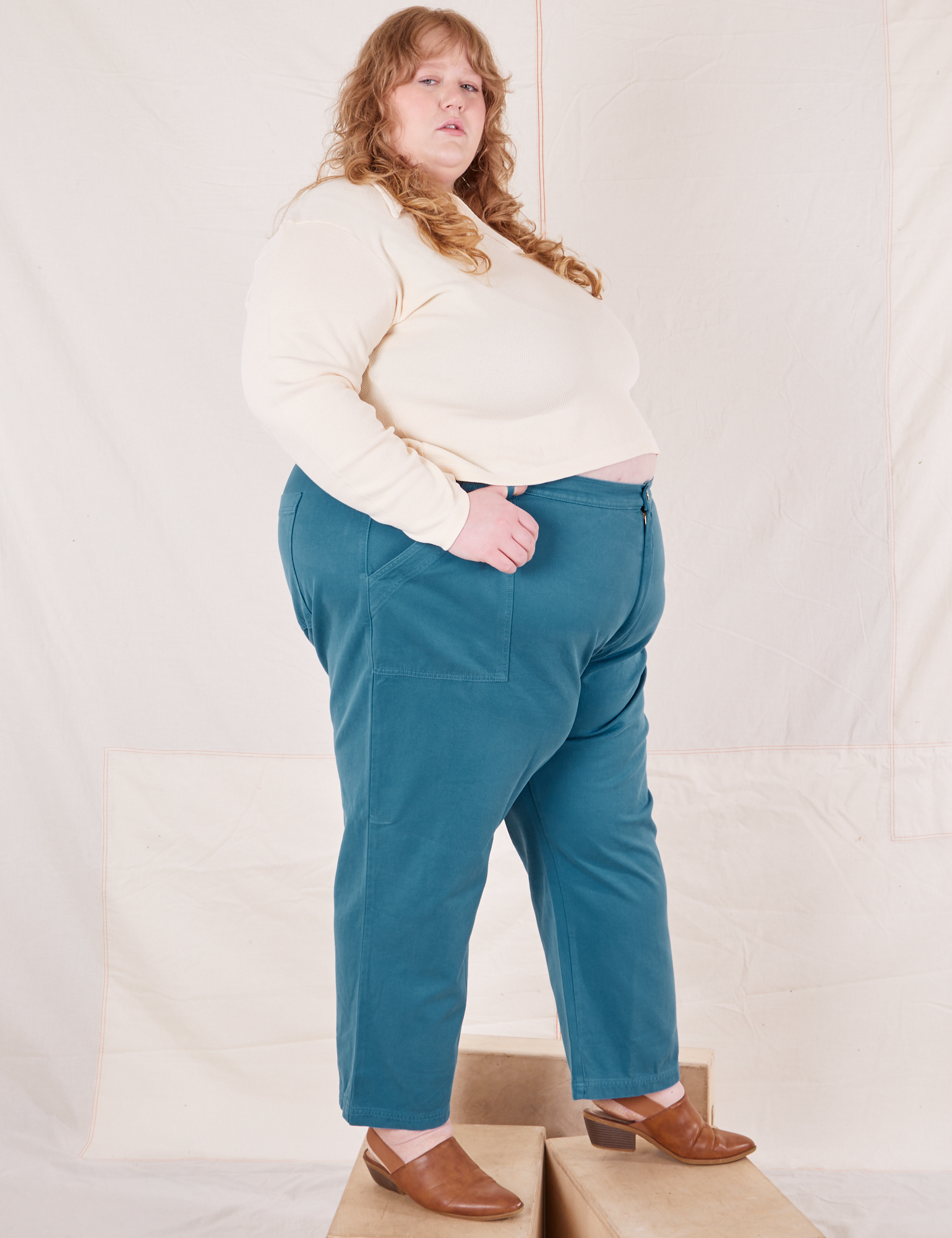 Side view of Organic Work Pants in Marine Blue and vintage off-white Long Sleeve Fisherman Polo on Catie