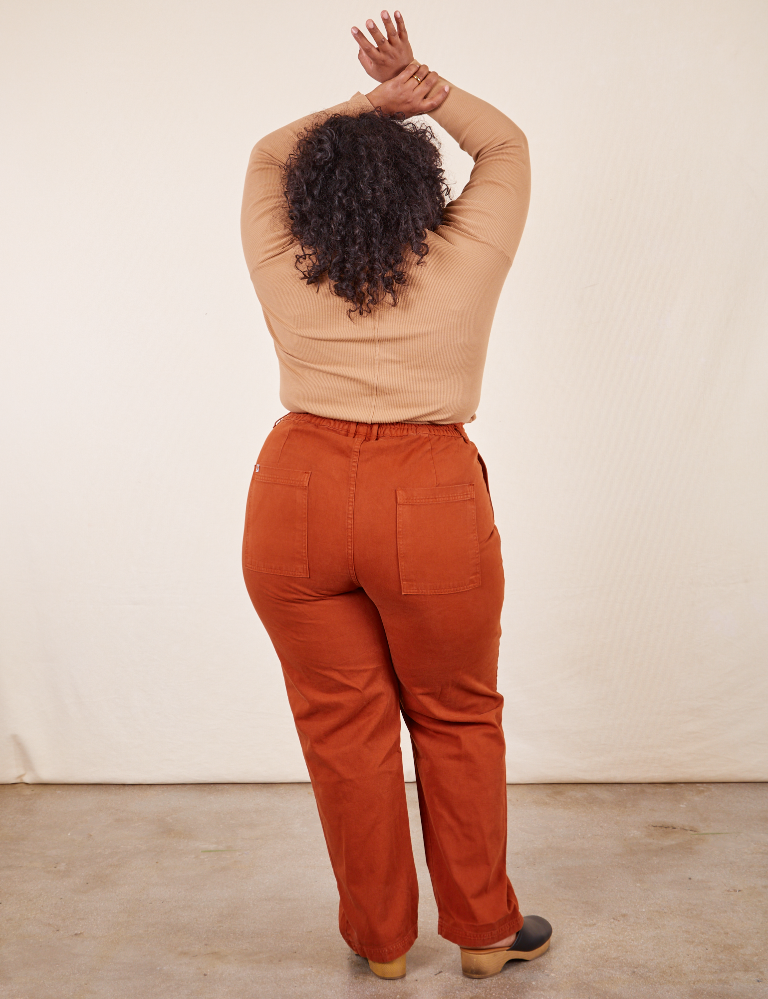 Back view of Work Pants in Burnt Terracotta and tan Wrap Top on Morgan