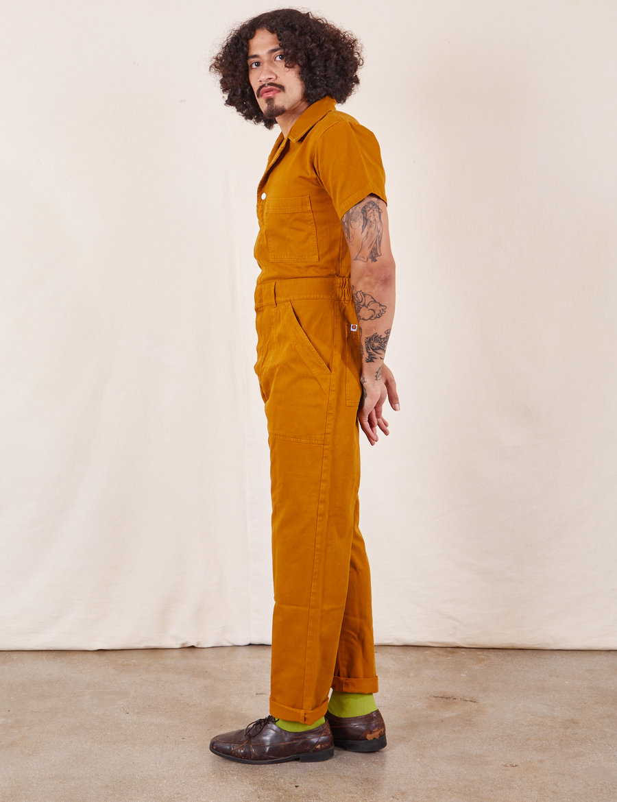Side view of Short Sleeve Jumpsuit in Spicy Mustard worn by Jesse