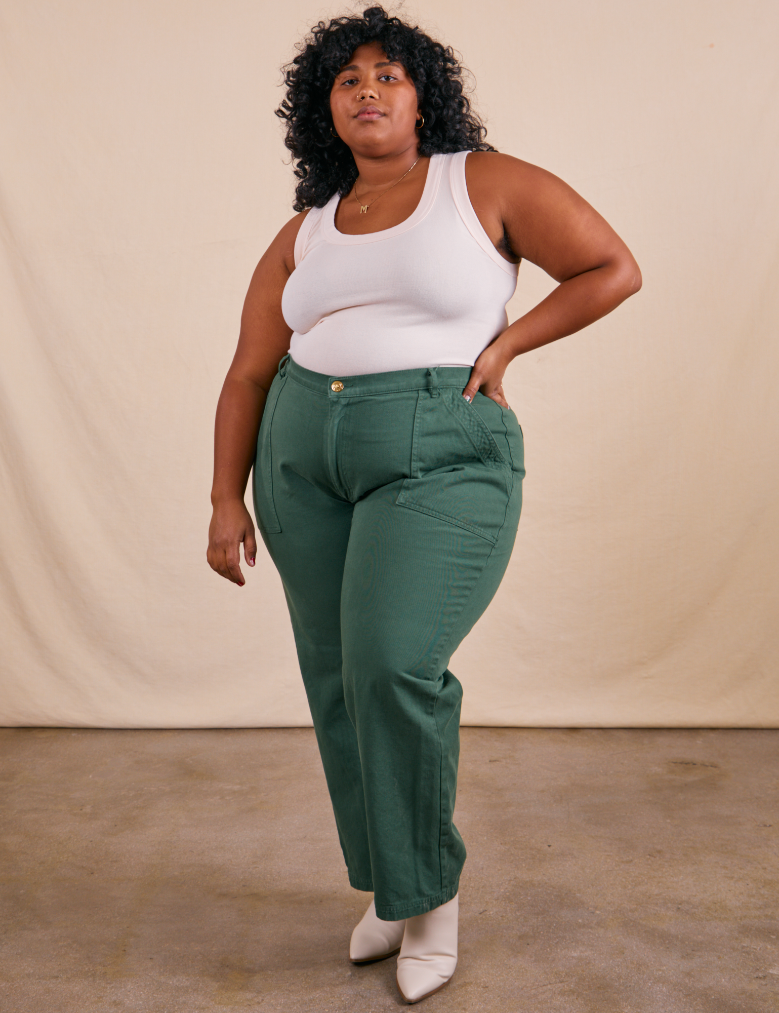Morgan is 5&#39;5&quot; and wearing 3XL Work Pants in Dark Emerald Green paired with vintage off-white Tank Top