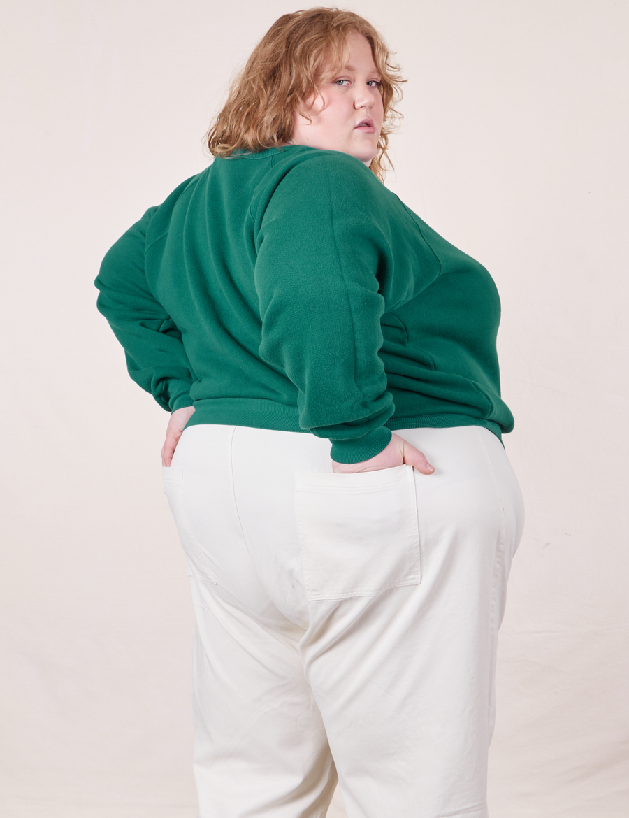 Angled back view of Heavyweight Crew in Hunter Green and vintage off-white Western Pants