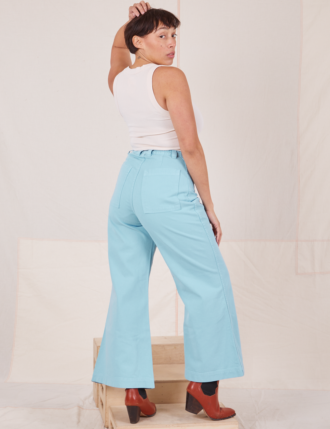 Back view of Bell Bottoms in Baby Blue and vintage off-white Tank Top worn by Tiara