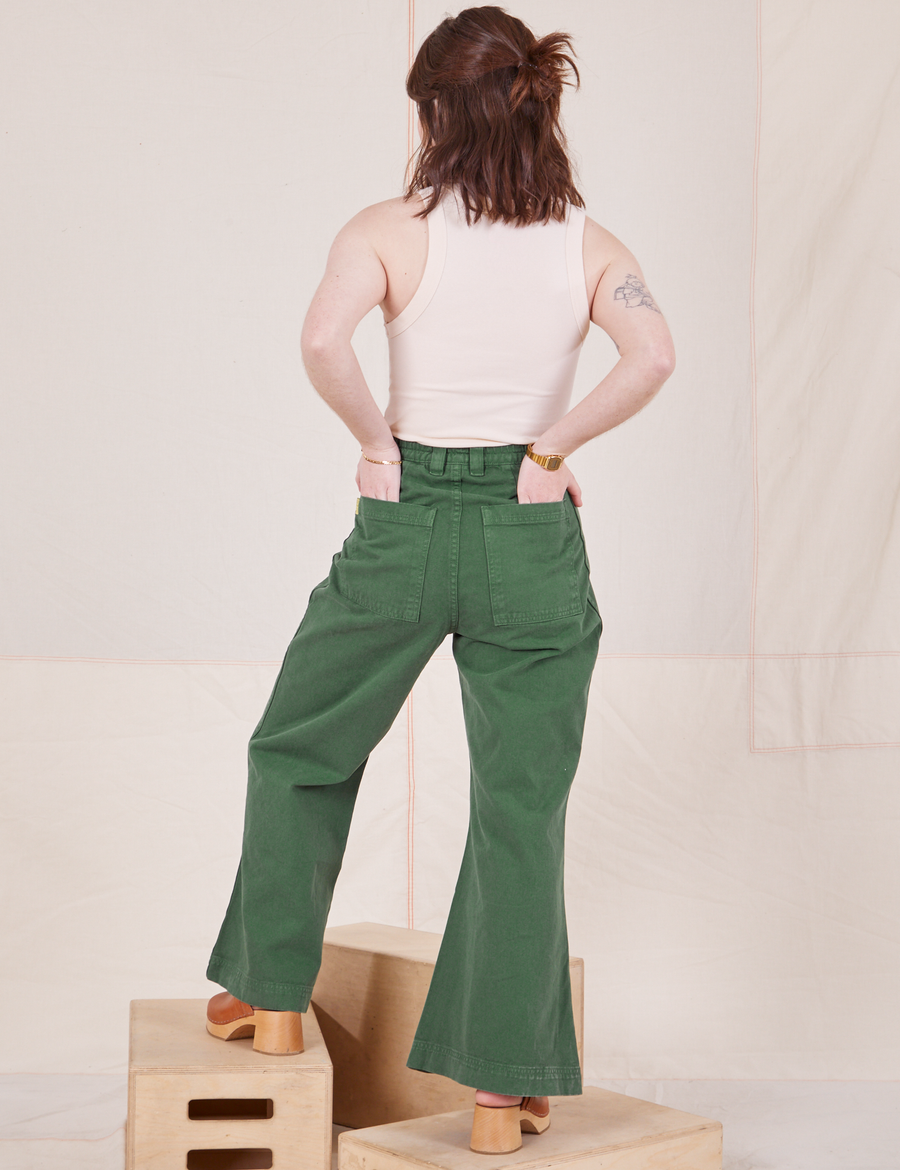 Back view of Bell Bottoms in Dark Emerald Green and vintage off-white Tank Top worn by Hana