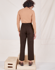 Back view of Heritage Trousers in Espresso Brown and tan Essential Turtleneck worn by Jesse