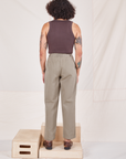 Back view of Heritage Trousers in Khaki Grey and espresso brown Tank Top worn by Jesse