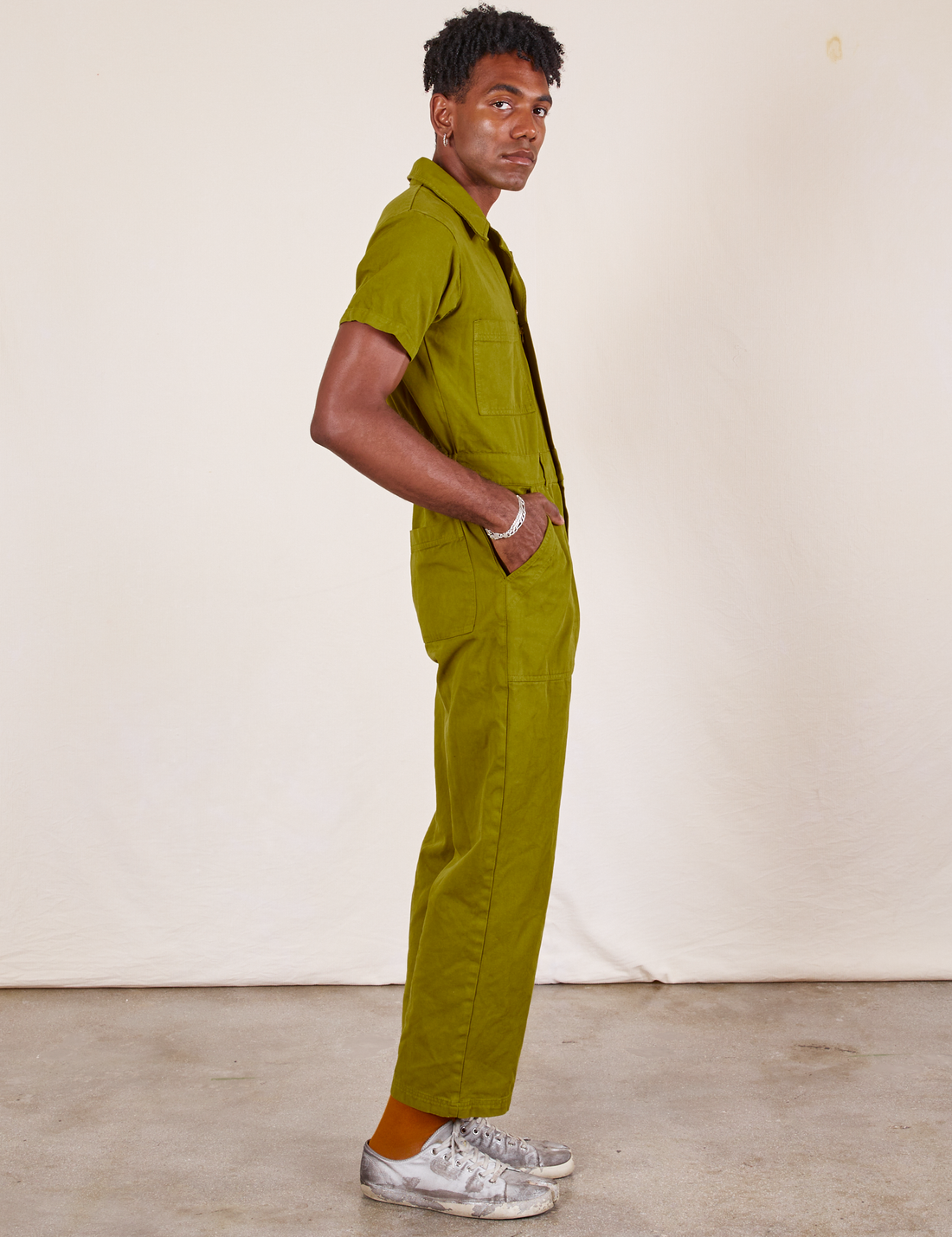 Side view of Short Sleeve Jumpsuit in Olive Green worn by Jerrod