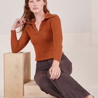 Alex is wearing Long Sleeve Fisherman Polo in Burnt Terracotta and espresso brown Western Pants