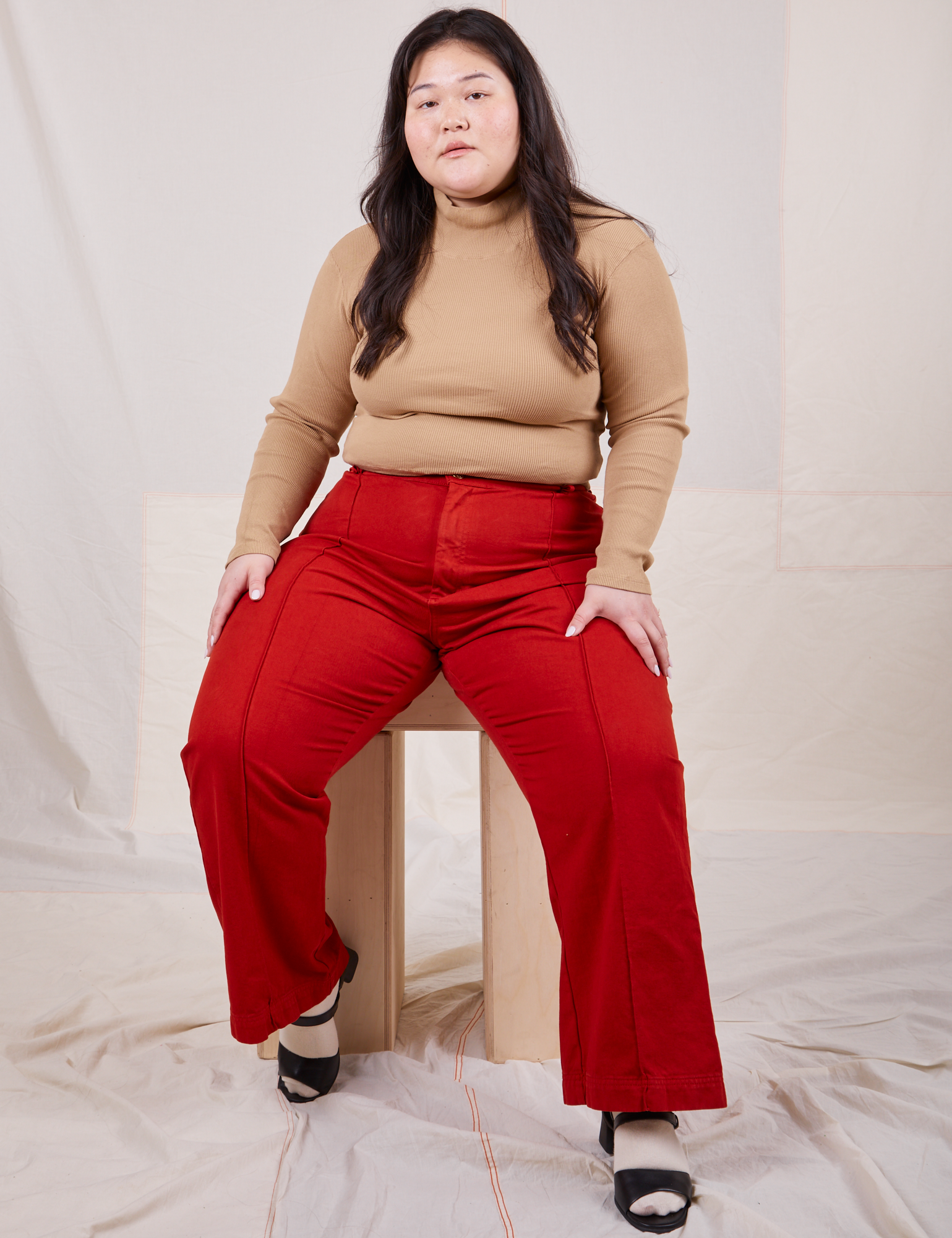 Ashley is wearing Essential Turtleneck in Tan