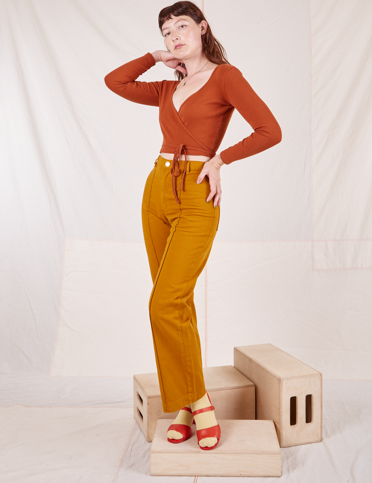 Alex is wearing Wrap Top in Burnt Terracotta and spicy mustard Western Pants