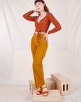 Alex is wearing Wrap Top in Burnt Terracotta and spicy mustard Western Pants