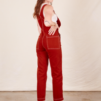 Angled back view of Original Overalls in Paprika worn by Alex