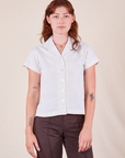 Alex is wearing Pantry Button-Up in Vintage Tee White and espresso brown Western Pants