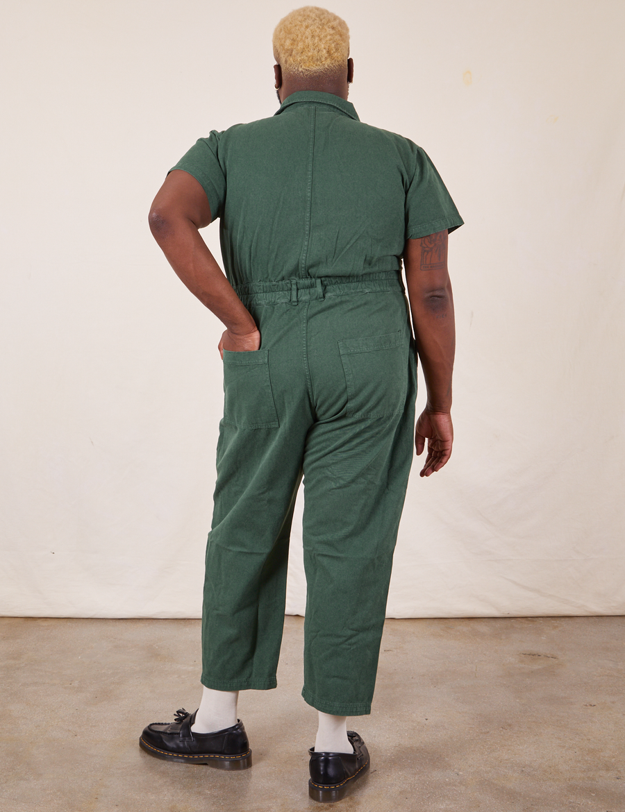 Back view of Short Sleeve Jumpsuit in Dark Emerald Green worn by Elijah