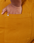 Western Pants in Spicy Mustard hand in back pocket close up on Morgan