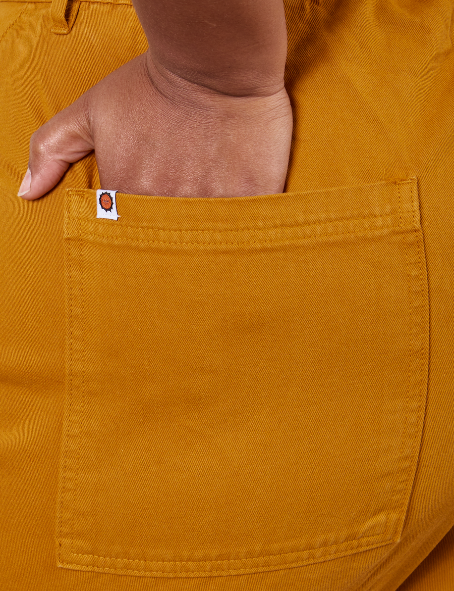 Western Pants in Spicy Mustard hand in back pocket close up on Morgan