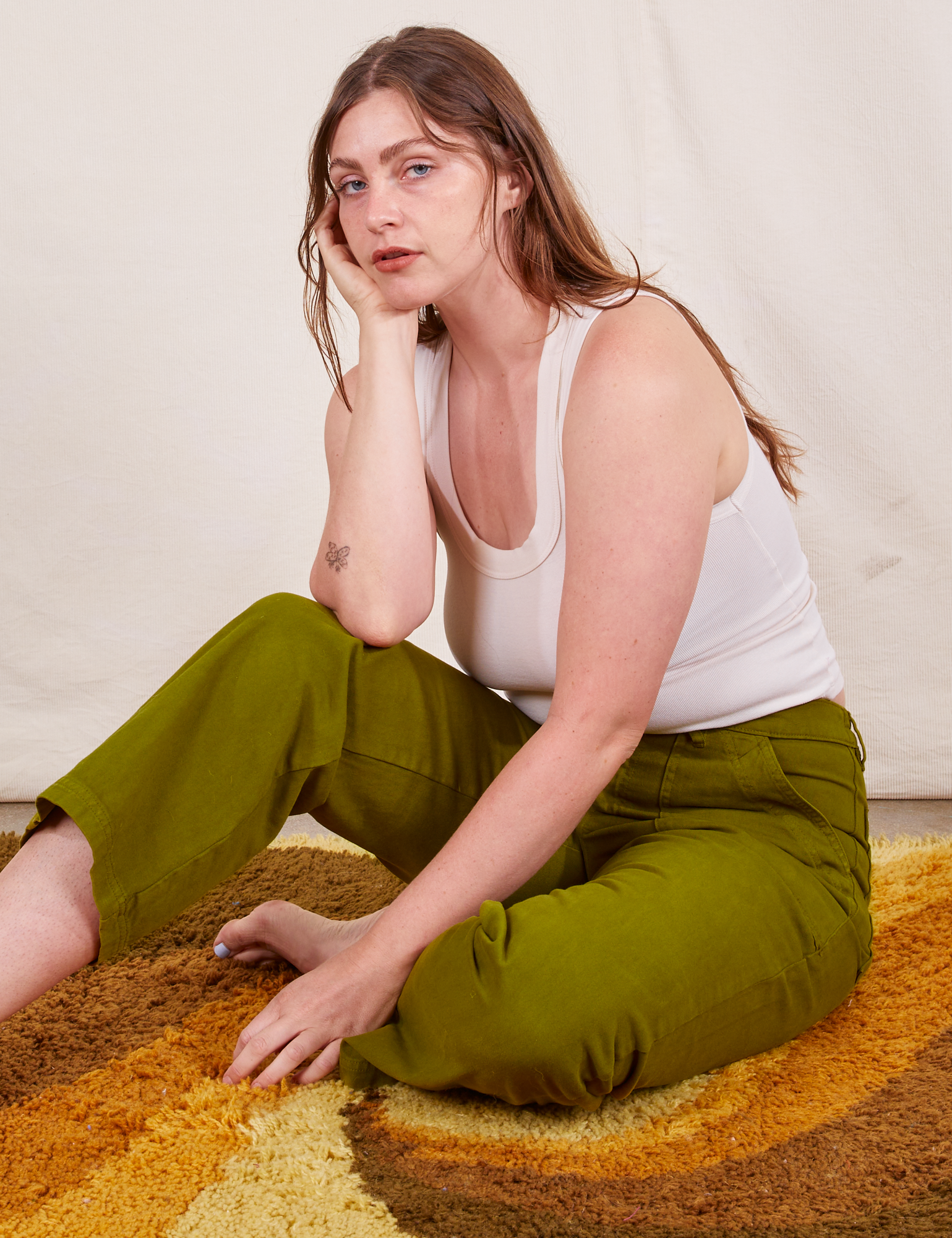 Allison is wearing Work Pants in Olive Green and vintage off-white Tank Top.