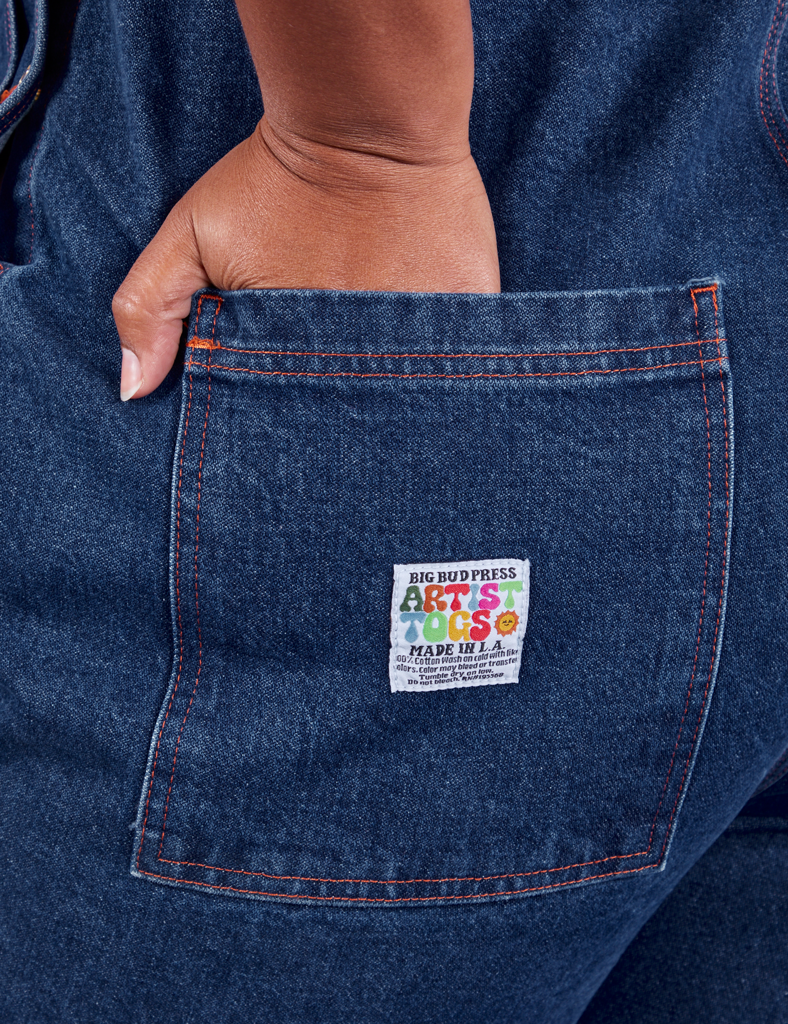 Indigo Denim Original Overalls in Dark Wash hand in back pocket on Morgan