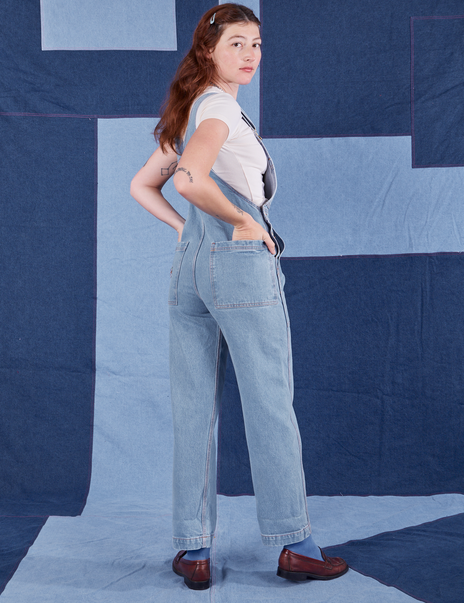 Angled back view of Indigo Denim Original Overalls in Light Wash worn by Alex